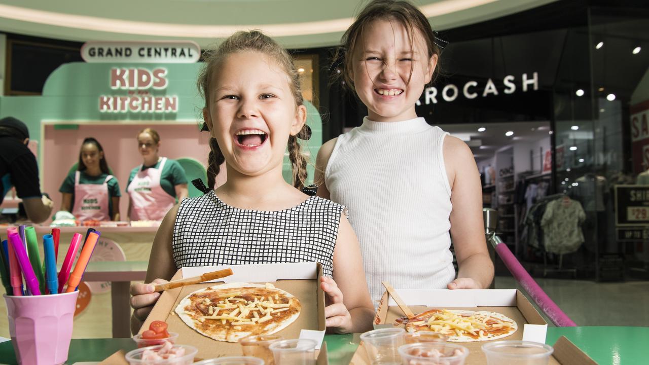 Molly (left) and Charleigh Dalley enjoy the Kids in the Kitchen school holiday activity at Grand Central, Monday, January 16, 2023. Picture: Kevin Farmer