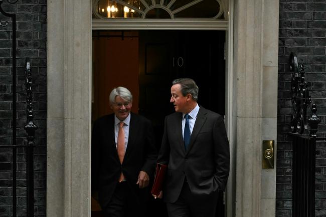 UK Foreign Secretary David Cameron (R) and development minister Andrew Mitchell at 10 Downing Street on November 14, 2023