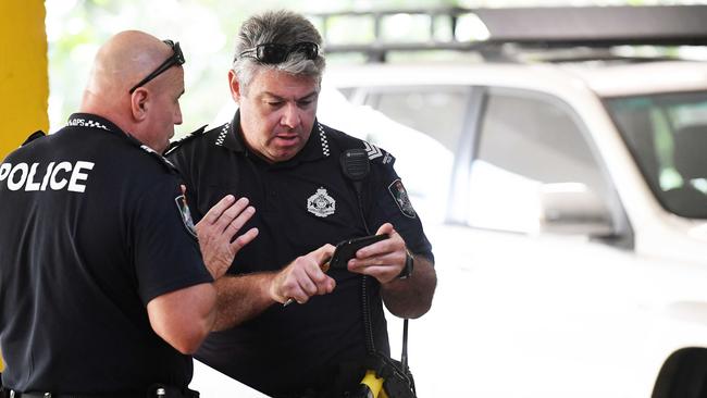 Police establish a crime scene in the car park under Super Cheap Auto after a man was stabbed in Nambour. Pictured, Sergeant Devon Cupitt (right). Photo: Patrick Woods.