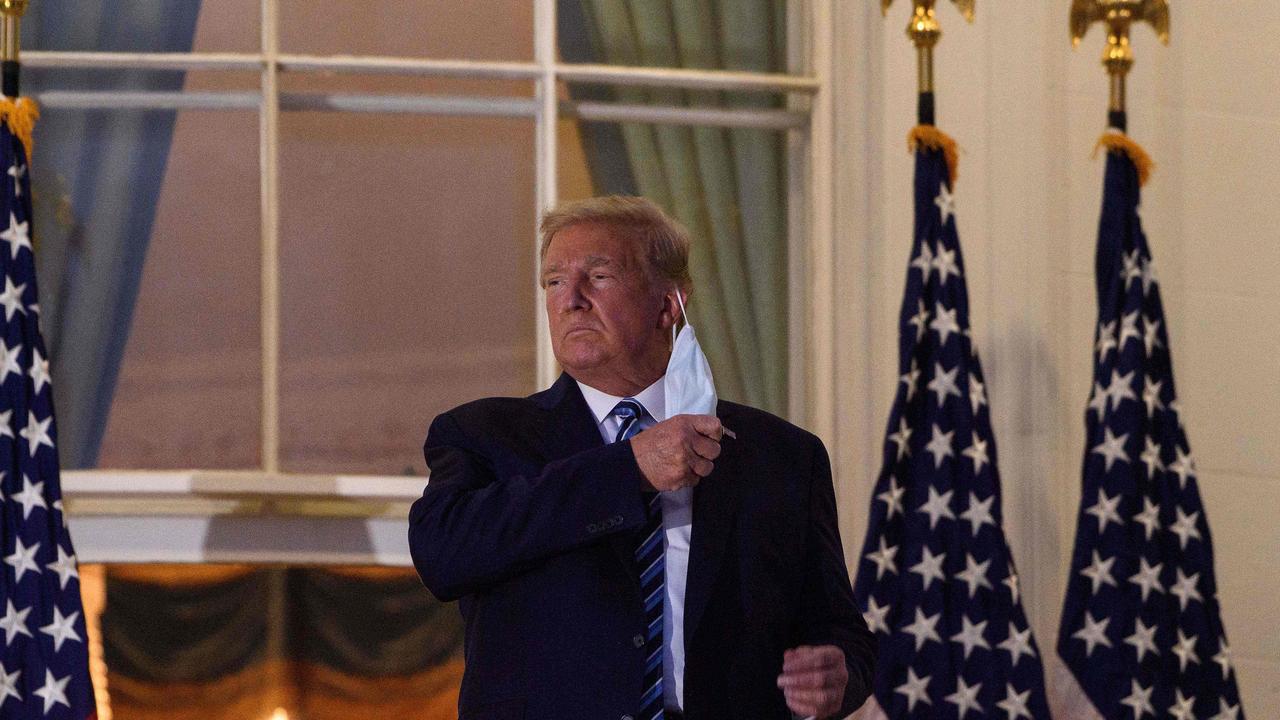 US President Donald Trump photographed removing his face mask while infectious with COVID-19. Picture: Nicholas Kamm/AFP