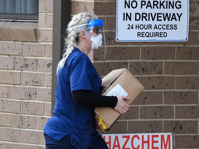 A staff member carries a delivery at the Menarock Life aged care facility on Tuesday. Picture: William West/AFP