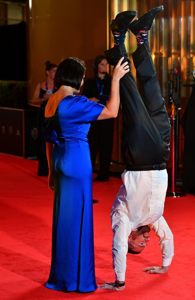 Brisbane great and 2001 Brownlow Medalist Jason Akermanis performs his trademark handstand on the red carpet. Picture: Getty