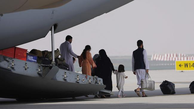 Evacuees from Afghanistan disembark off a Royal Air Force military transport aircraft which landed at Al-Maktoum International Airport in the United Arab Emirates. Picture: AFP