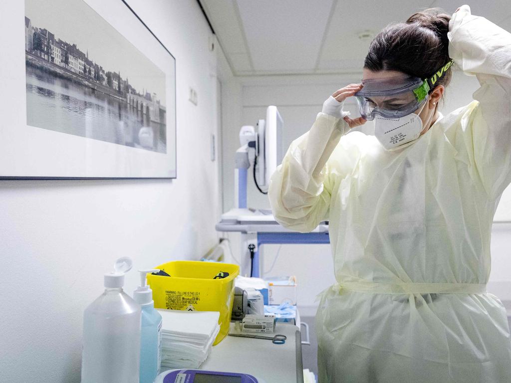 A health worker in a Dutch hospital puts on protective equipment against Covid. Picture: AFP