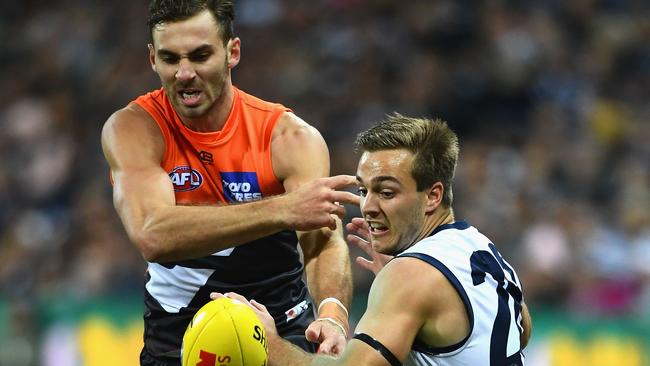 Jeremy Finlayson of the Giants (left) and Cory Gregson of the Cats compete for the ball on Friday night.