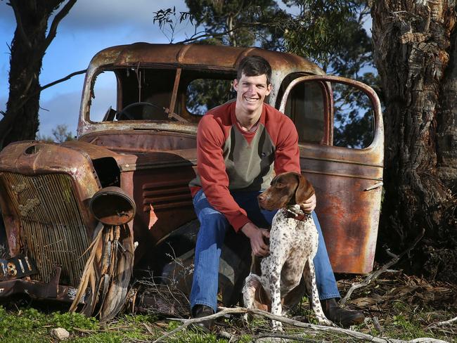 Justin Clarke and his dog Bindi on the family farm at Booleroo Centre in 2016. Justin's AFL career with the Brisbane Lions was ended by repeated concussions. Picture: Sarah Reed