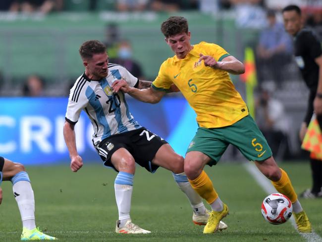 BEIJING, CHINA - JUNE 15: Jordan Bos of Australia controls the ball against Alexis Mac Allister and Nicolas Gonzalez of Argentina during the international friendly match between Argentina and Australia at Workers Stadium on June 15, 2023 in Beijing, China. (Photo by Di Yin/Getty Images)