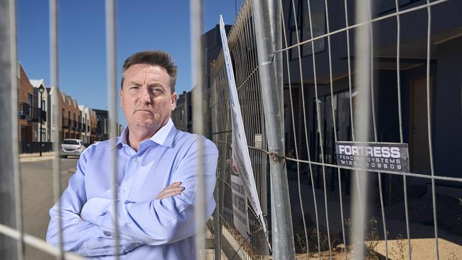 Resident Andrew Curran at home in Port Adelaide where an unfinished development has been left stagnant for months. Picture: Matt Loxton