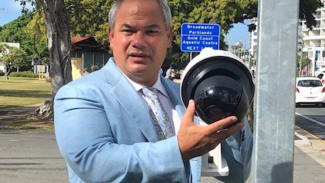 Mayor Tom Tate with a new security camera.