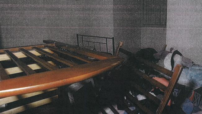 A broken cot inside one of the bedrooms.