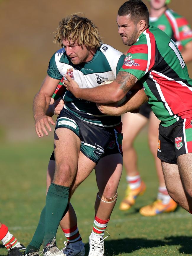 Swans champion Murray Goldsworthy hits it up against the Nambour Crushers.