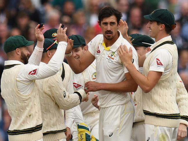 Australia's Mitchell Starc (C) celebrates with teammates after taking the wicket of England's Jonny Bairstow for 17 during the fourth day of the fourth Ashes cricket Test match between England and Australia at Old Trafford in Manchester, north-west England on September 7, 2019. (Photo by Oli SCARFF / AFP) / RESTRICTED TO EDITORIAL USE. NO ASSOCIATION WITH DIRECT COMPETITOR OF SPONSOR, PARTNER, OR SUPPLIER OF THE ECB