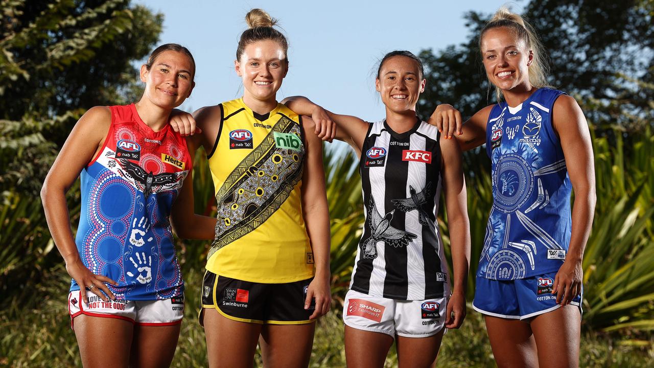 Melbourne’s Krstel Petrevski, Richmond’s Maddy Brancatisano, Collingwood’s Aleisha Newman and North Melbourne’s Kaitlyn Ashmore show off their clubs’ Indigenous Round jumpers. Picture: Michael Klein