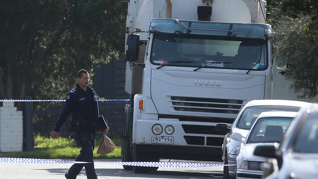 Police and the rubbish truck on the scene at the corner of Butler and Young Streets in Preston. Picture: Hamish Blair