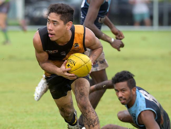 Nightcliff’s Ryan Mu finds himself in space in tough muddy conditions against Darwin Buffaloes. Picture: PATRINA MALONE