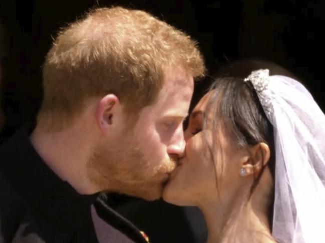 In this frame from video, Britain's Prince Harry and Meghan Markle kiss after their wedding ceremony at St. George's Chapel in Windsor Castle in Windsor, near London, England, Saturday, May 19, 2018.  (UK Pool via AP)