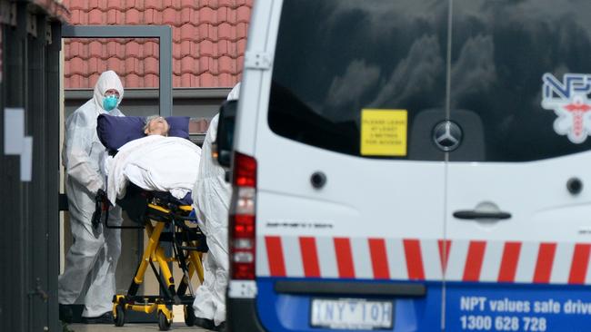 Medical staff remove patients from St Basil's Home for the Aged at Fawkner. Picture: NCA NewsWire / Andrew Henshaw