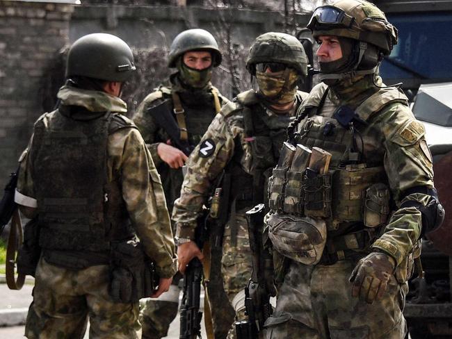 Russian soldiers patrol a street on April 11, 2022, in Volnovakha in the self-proclaimed Donetsk People's Republic (DNR). The picture was taken during a trip organized by the Russian military. (Photo by Alexander NEMENOV / AFP)