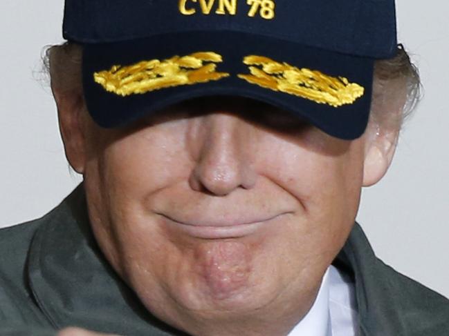 President Donald Trump points to the audience of Navy and shipyard personnel after speaking aboard nuclear aircraft carrier Gerald R. Ford at Newport News Shipbuilding in Newport News, Va., Thursday, March 2, 2017. The ship which is still under construction is due to be delivered to the Navy later this year. (AP Photo/Steve Helber)