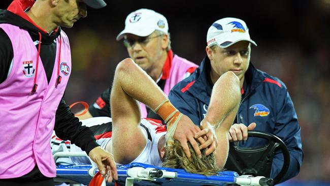 Young defender Hugh Goddard gets taken from the ground on a stretcher. Picture: Tom Huntley