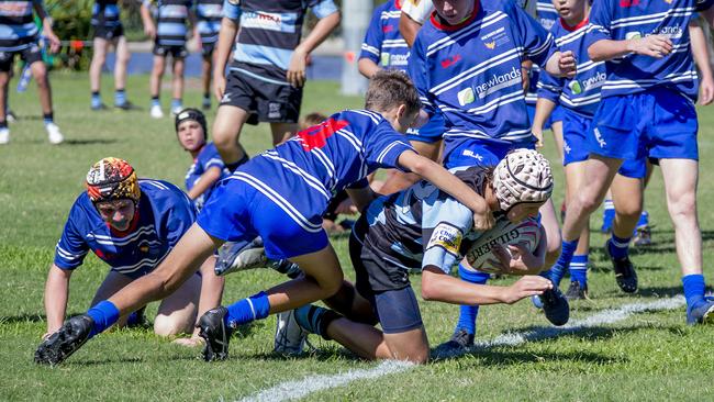Day One of King of the Country rugby tournament at James Overell Park, Southport. Maroochydore Swans U14s' ( big stripes - blue) in action against USQ Saints U14s' (darker blue small stripes). Maroochydore Swans U14s Jarvis Wood scoring a try . Picture: Jerad Williams