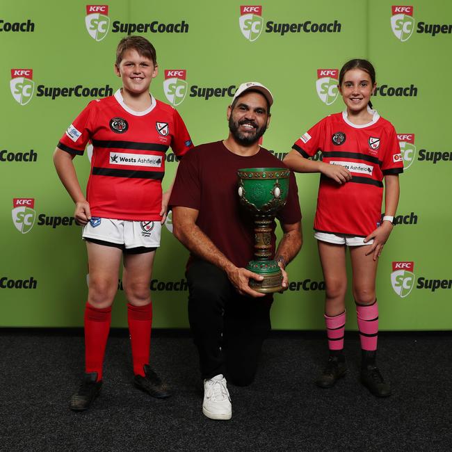 Greg Inglis holds the Holy Grail with fans Billy Thomas (11) and Zoe Mara (11). Photo: Brett Costello