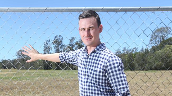 Sam O'Connor at the Helensvale Glink station where a six lane road was supposed to be built — he is stunned by the latest government response.