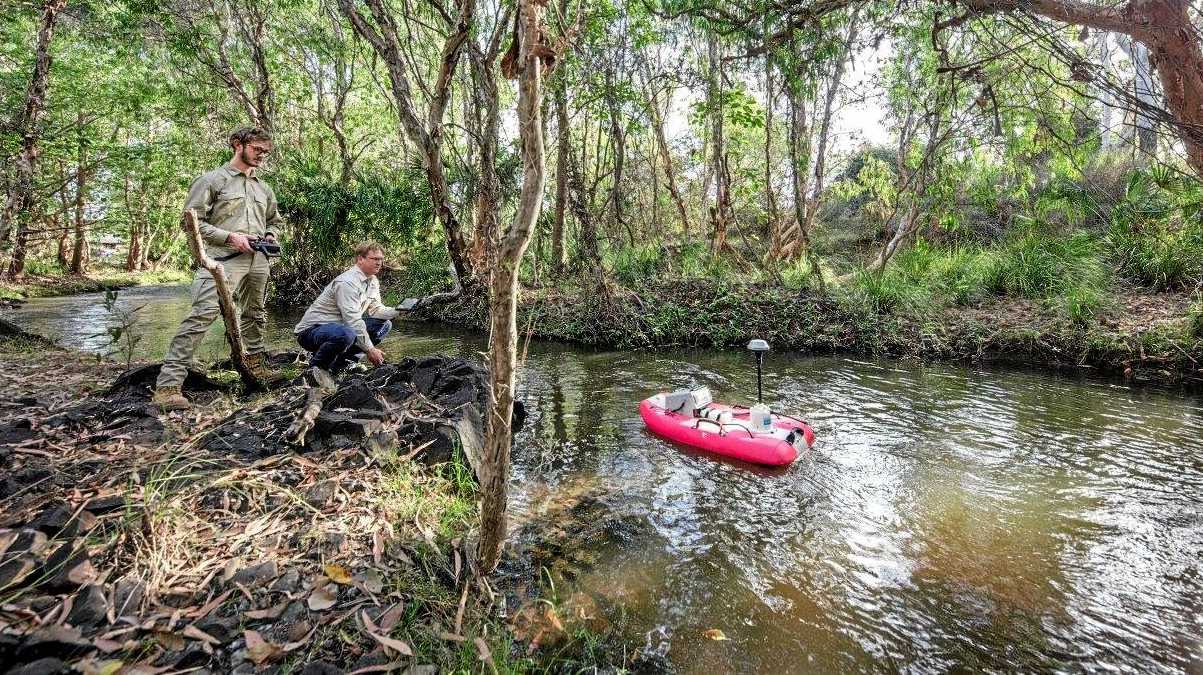 Queensland Department of Environment and Science officers from the water quality and investigations team gathering results from water quality monitoring sensors. Picture: Contributed