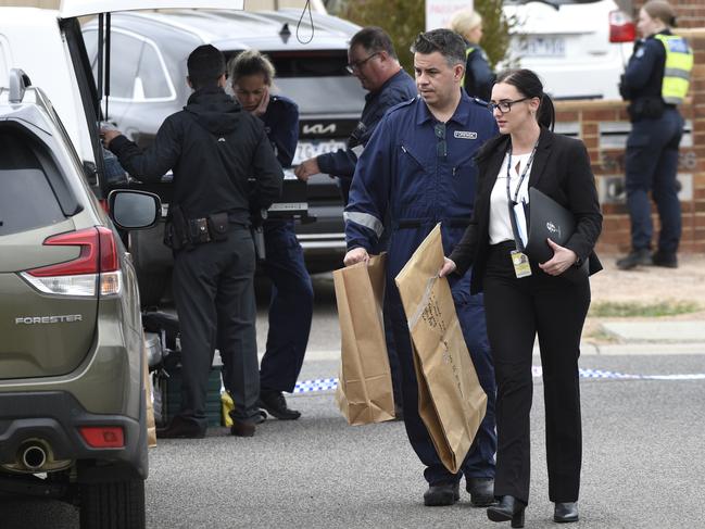 Detectives remove bagged evidence. Picture: Andrew Henshaw