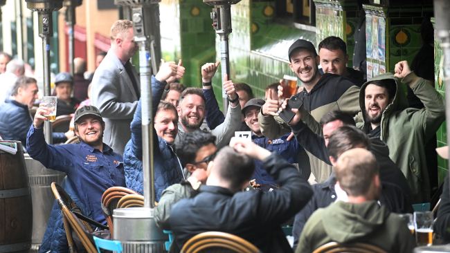 A group of men pose for the camera as they enjoy  a drink at the Mercantile Hotel in The Rocks on freedom day. Picture: NCA NewsWire / Jeremy Piper