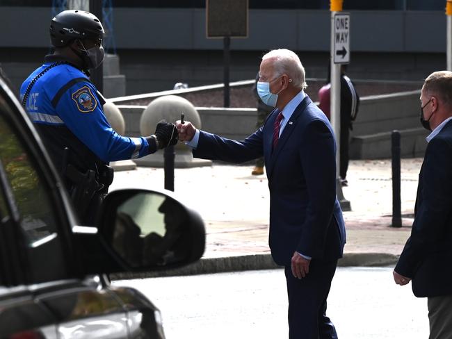 Democratic Presidential Candidate Joe Biden fists bumps a police officer in Wilmington, Delaware. Picture: AFP