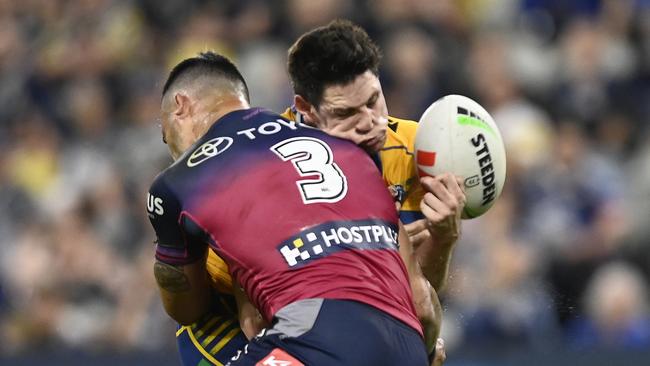 Mitch Moses of the Eels is tackled by Valentine Holmes. Photo by Ian Hitchcock/Getty Images)