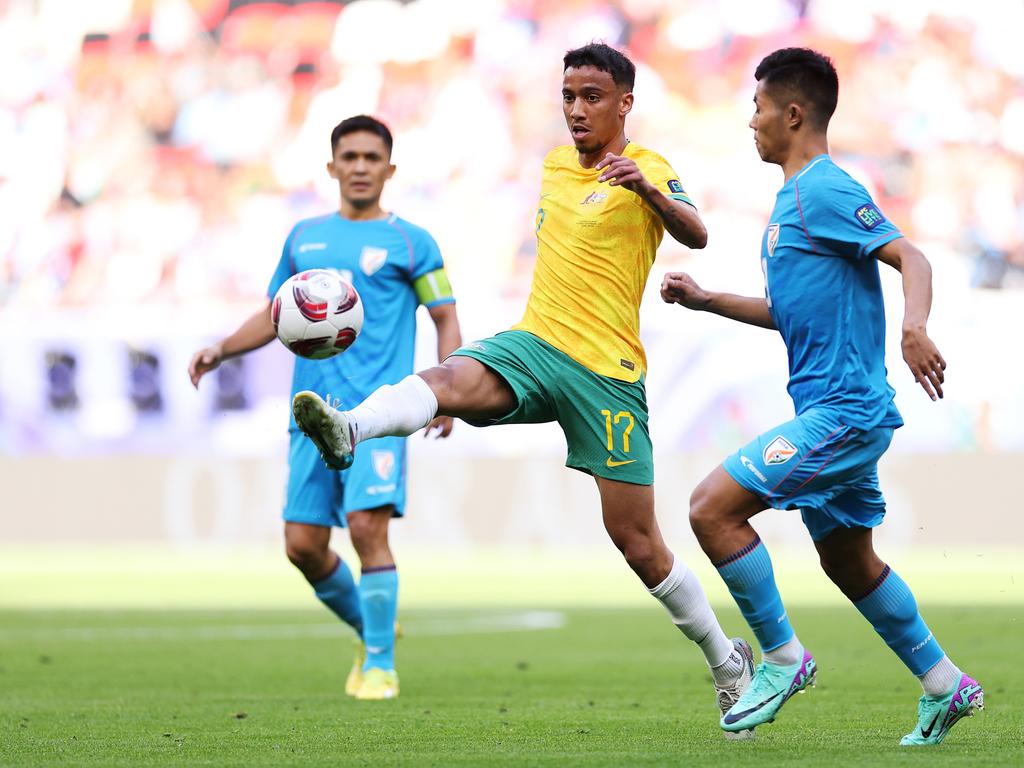 DOHA, QATAR - JANUARY 13: Keanu Baccus of Australia is challenged by Lalengmawia Apuia of India during the AFC Asian Cup Group B match between Australia and India at Ahmad Bin Ali Stadium on January 13, 2024 in Doha, Qatar. (Photo by Robert Cianflone/Getty Images)