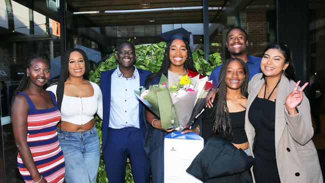 Marwa Kingok, Joanne Olasoji, Liep Gatwech, Victoria, Blessing and Daniel Olasoji, and Amy Thalluri celebrate graduation. Picture: Alan Barber