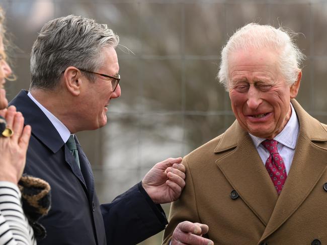 NEWQUAY, ENGLAND - FEBRUARY 10: King Charles III (C) shares a joke with Britain's Prime Minister Keir Starmer (L) during a tour of the Newquay Orchard on February 10, 2025 in Newquay, England. King Charles III was joined by Britain's Prime Minister Keir Starmer and Deputy Prime Minister Angela Rayner as they visited the Newquay Orchard, a community garden offering a range of classes including vocational learning, adult education, wellbeing sessions and art sessions. (Photo by Leon Neal/Getty Images)