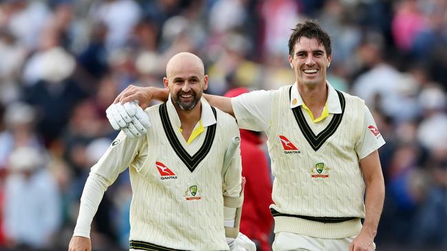 A victorious Nathan Lyon walks off with captain Pat Cummins after their heroic 55-run matchwinning partnership. Picture: Getty