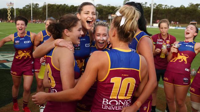 Brisbane players celebrate the win over GWS in Round 1.