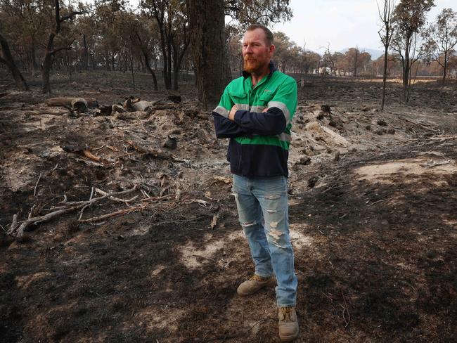 Jason Kowald on the burnt out land next to his home in Wallangarra. Picture: Liam Kidston