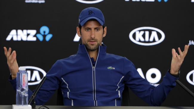 Novak Djokovic gestures during a press conference at the Australian Open.
