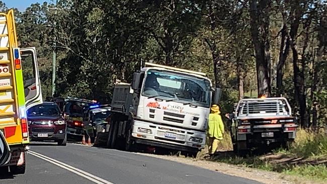 Emergency services on the Mary Valley Highway, where three people are being assessed by paramedics.