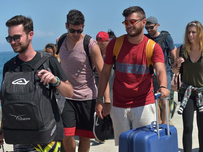 Evacuated tourists arrive from nearby Gili Trawangan island at the port at Bangsal in northern Lombok. Picture: AFP