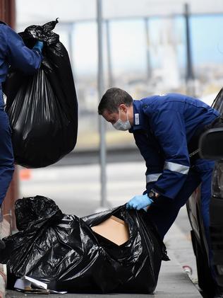 Police sift through rubbish for evidence in Anthony Street. Picture: Nicole Garmston.