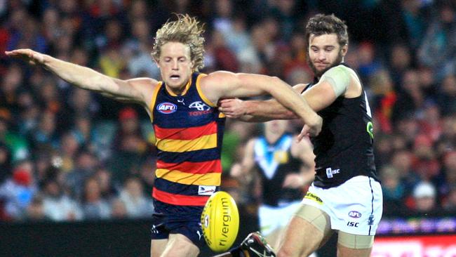 The Power's Sam Gray chases Crows captain Rory Sloane. He is also yet to taste success against the Crows. Picture: Phil Williams