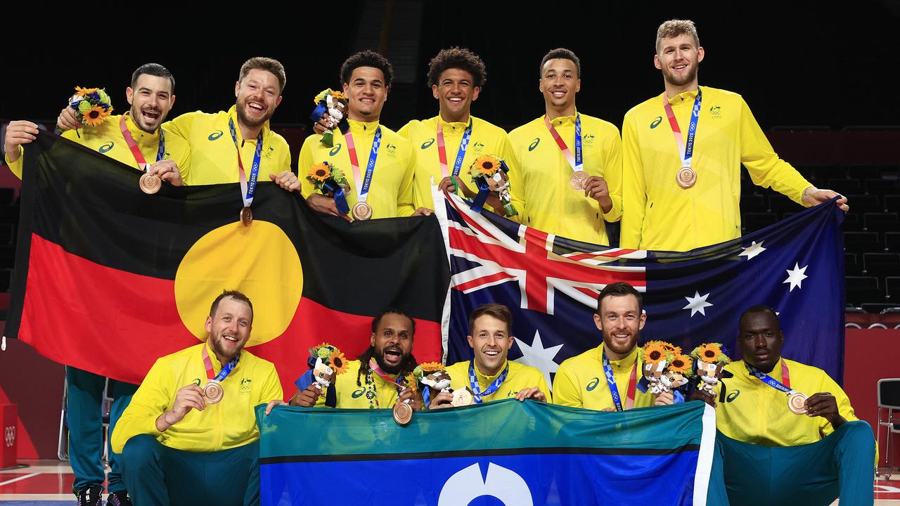 Patty Mills and Australia celebrates winning the Bronze medal playoff Basketball game against Slovenia at the Saitama Super Arena. Pics Adam Head