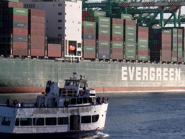 SAN PEDRO, CALIFORNIA - NOVEMBER 24: A tour boat passes a container ship at the Port of Los Angeles on November 24, 2021 in San Pedro, California. The Ports of Los Angeles and Long Beach have suspended a plan to charge shippers fees for shipping container storage as a backlog of empty containers at the ports has decreased since last month.   Mario Tama/Getty Images/AFP == FOR NEWSPAPERS, INTERNET, TELCOS & TELEVISION USE ONLY ==