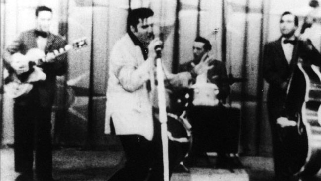 Elvis Presley performing Hound Dog, circa 1956, with Scotty Moore, left.