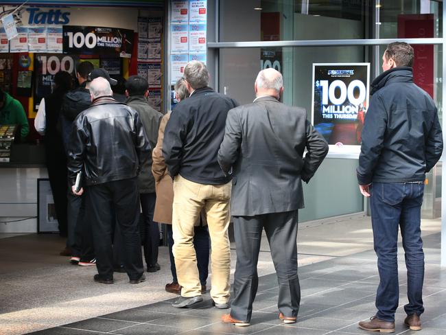 Queues build for tickets to the $100 million jackpot in Melbourne. Picture: David Caird