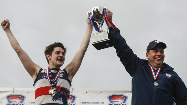 Highett captain Tom Brown and coach Sam Hecker raise the premiership cup. Picture: Valeriu Campan