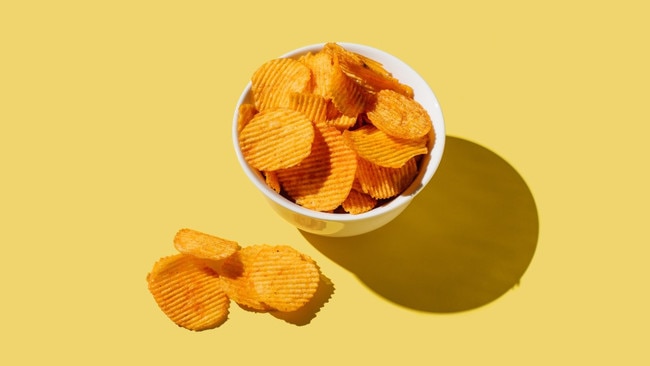 Eating one packet of crisps a day is the equivalent of pouring almost five litres of cooking oil down your throat every year. Picture: Getty Images