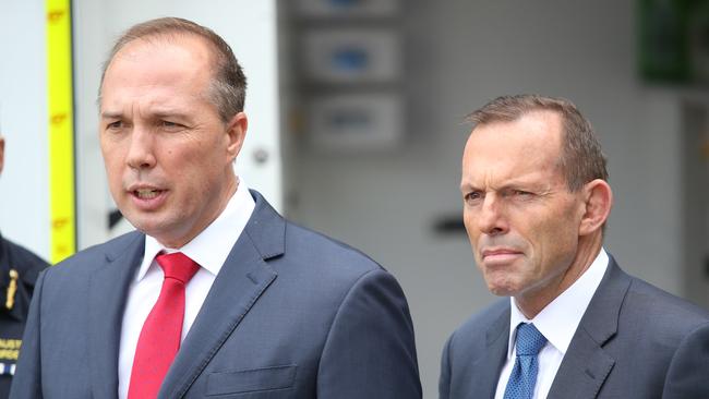 Peter Dutton, with then prime minister Tony Abbott, talks to Border security staff at Brisbane Airport. Picture: Jono Searle